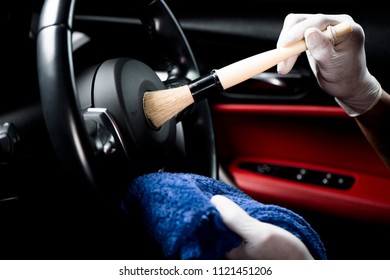 Car detailing series, Man use brush cleaning on hand wheel. - Shutterstock ID 1121451206