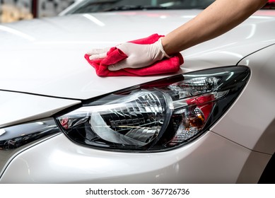 Car detailing series : Worker cleaning white car