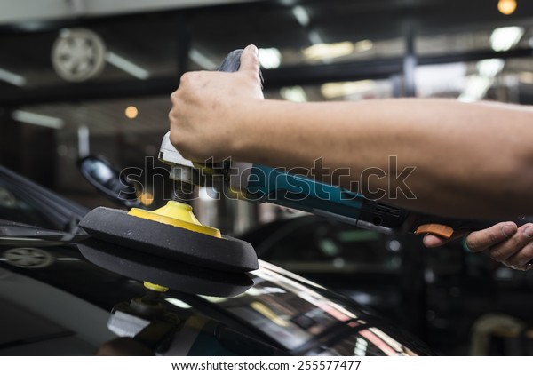 Car detailing\
series : Worker waxing black\
car