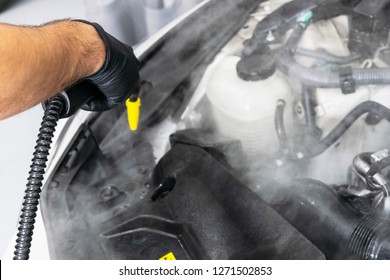 Car Detailing. Car Washing Cleaning Engine. Cleaning Car Engine Using Hot Steam. Hot Steam Engine Washing. Soft Lighting. Car Wash Station Worker Cleaning Vehicle. Vehicle Wash Concept