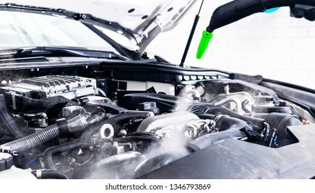 Car Detailing. Car Washing Cleaning Engine. Cleaning Car Using Hot Steam. Hot Steam Engine Washing. Soft Lighting. Car Wash Man Worker Cleaning Vehicle.