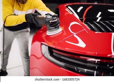 Car detailing - Worker with orbital polisher in auto repair shop. Selective focus. - Shutterstock ID 1681005724
