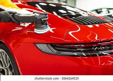 Car detailing - Worker with orbital polisher in auto repair shop. Selective focus. - Shutterstock ID 1864264525