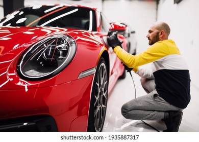 Car Detailing - Worker With Orbital Polisher In Auto Repair Shop. Selective Focus.