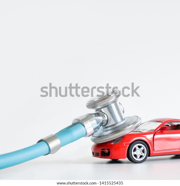 Car diagnostics,\
stethoscope and car on white background, concept of car inspection,\
repair and maintenance