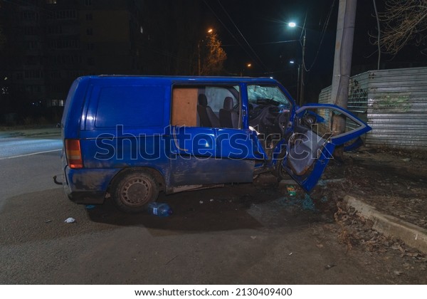 The car did not fit into the turn and crashed into a
pole. Night road accident on the street, damaged cars after a
collision in the city