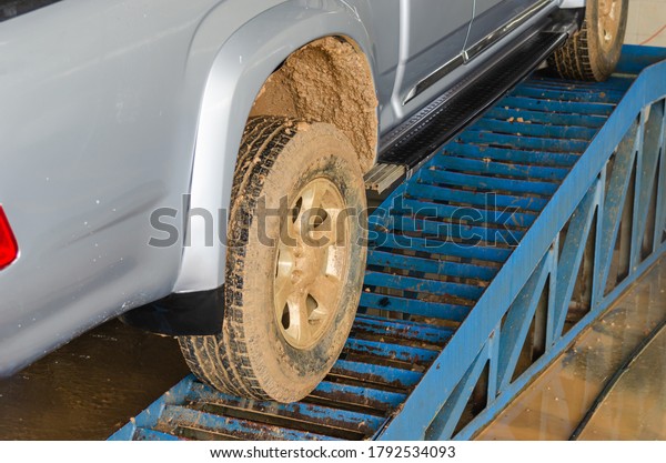 The car is dirty, there is muddy soil on\
the tires. Clean the car at the car\
care.