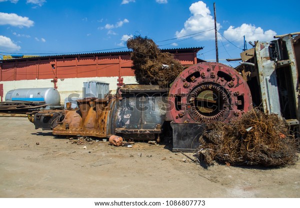 car disassembly, used\
cars; Piles of used cars disassembled in a cemetery yard car\
recycling center 