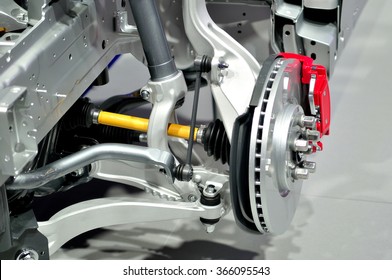 Car disc brake with red caliper, and  front suspension.