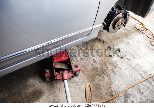 Car disk\
brake repair in garage, Wheel brake\
system
