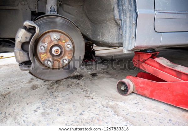 Car disk\
brake repair in garage, Wheel brake\
system