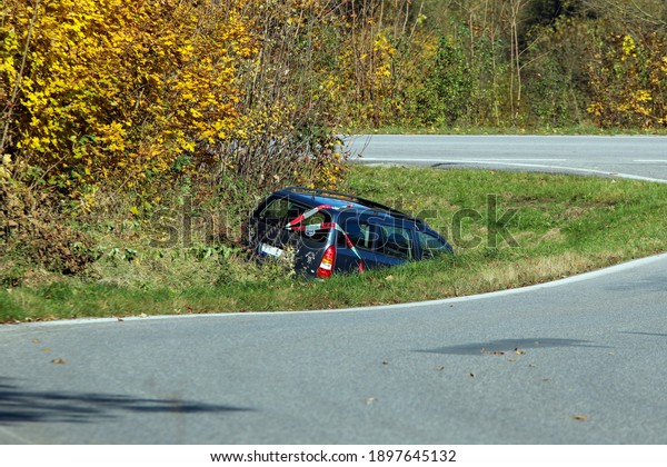 The car in the ditch by the road\
after the traffic accident. Abandoned and waiting for\
tow.