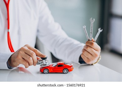 Car Doctor With Stethoscope In A Car Showroom