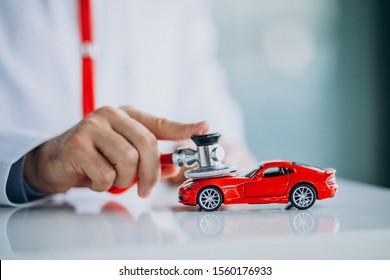 Car Doctor With Stethoscope In A Car Showroom