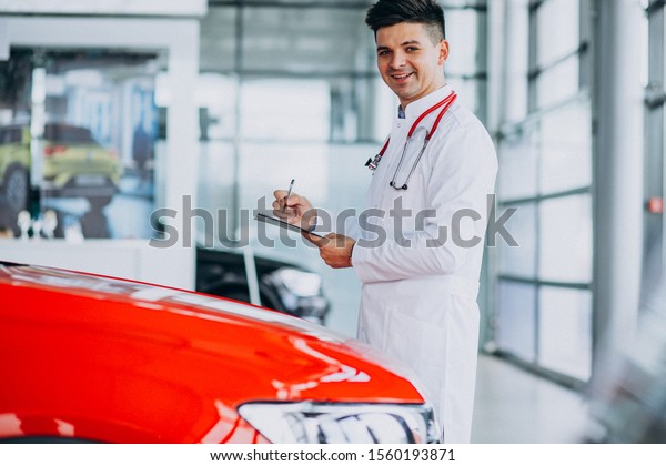 Car doctor with\
stethoscope in a car\
showroom