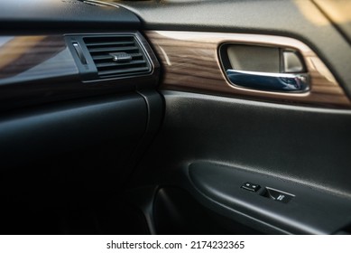 Car door control right panel. New car interior. Window lifters control. Armrest with setting adjustment button and blocking the opening and closing of doors. Car inside door chrome handle. Door trim. - Shutterstock ID 2174232365