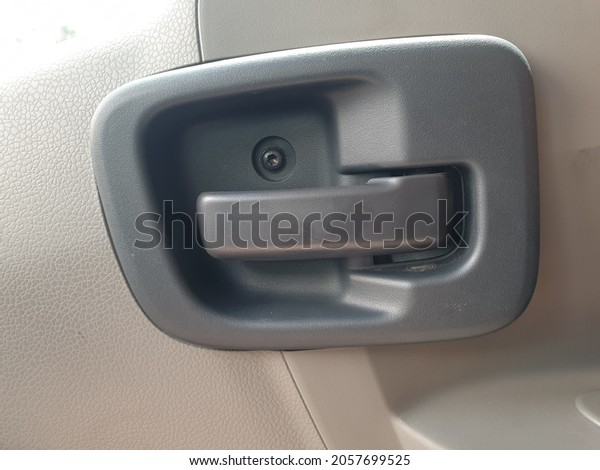 Car door handle closeup , Car door inside with door\
handle. This door handle is commonly found in old cars and pick up\
cars.