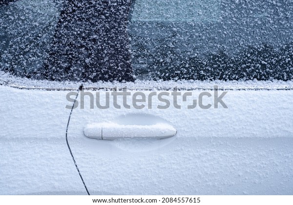 Car door\
handle and side window were covered with frost. Transportation in\
the winter cold season. Winter has\
started.