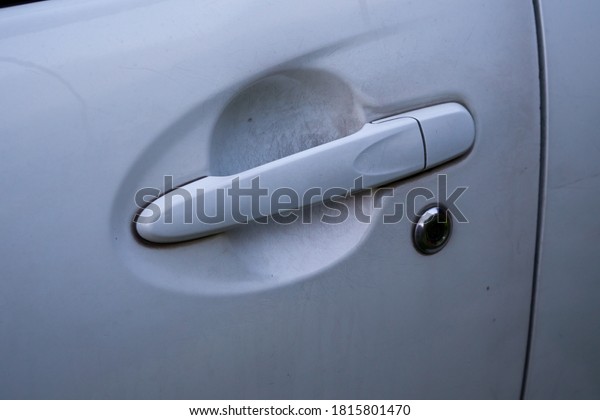 Car\
door handles with white paint scratched and key\
hole.