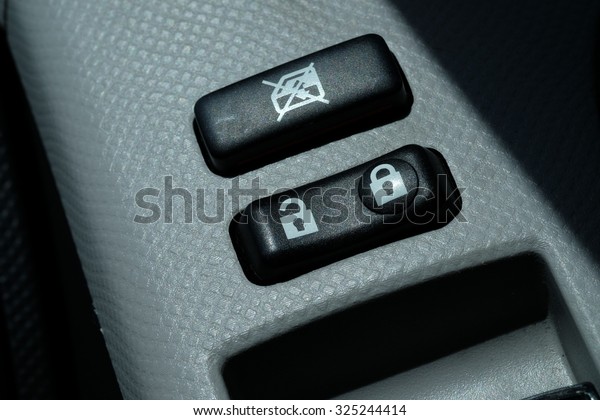 Car Door Lock Button Closeup. Electric Locking Button\
in Modern Car