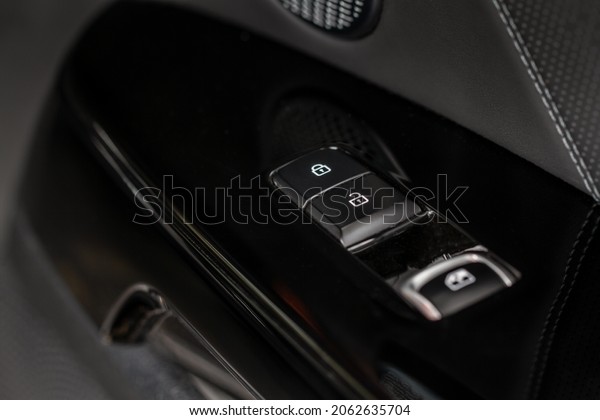Car door lock switch close up. A car\
lock button. Car door handle with door lock\
control.