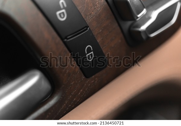 Car door lock
switch close-up. Car lock buttons in modern luxury vehicle with
leather interior, background
