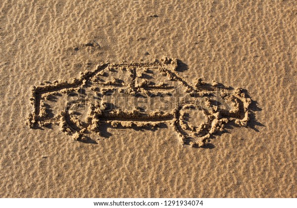 car drawing on\
sand