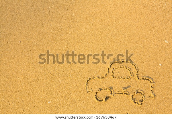 Car drawn on the sea beach\
sand.