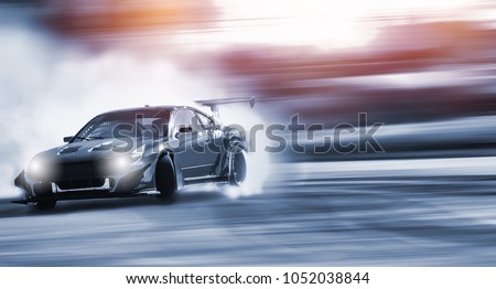 Car drifting, Blurred of image diffusion race drift car with lots of smoke from burning tires on speed track