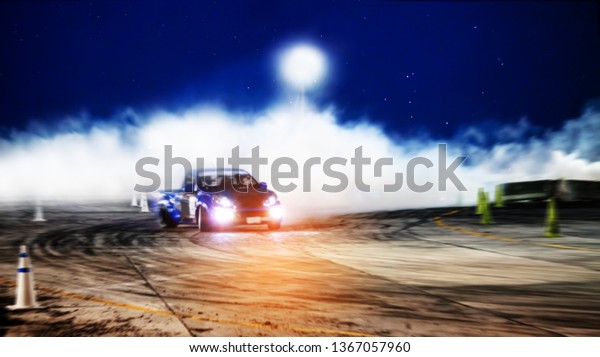 Car drifting,
Blurred of image diffusion race drift car with lots of smoke from
burning tires on speed
track