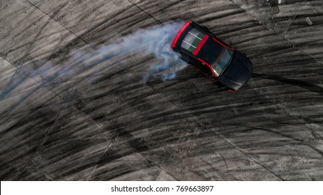 Car drifting, Drifting car on race track with smoke, Abstract texture and background black tire tracks skid on asphalt road, Wheel tire tracks background, Car tire track skid mark on race track.