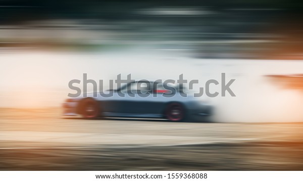 car drifting, Sport car\
wheel drifting and smoking on blurred background. Motorsport\
concept.