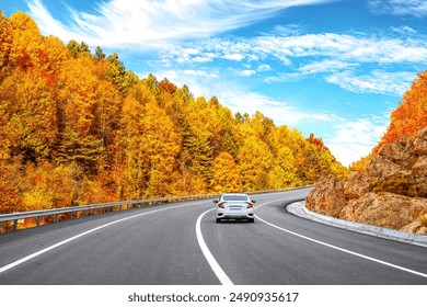 car drive on beautiful road landscape surrounded by colorful trees in autumn season. Autumn landscape on the highway in mountains. Autumn colors on beautiful road in colorful forest. Fall background. - Powered by Shutterstock