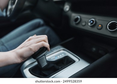 Car, driver, automatic gearbox, shift knob, steering wheel a person is driving a car, adjusting the automatic gearbox using the shift knob located on the steering wheel for better control
