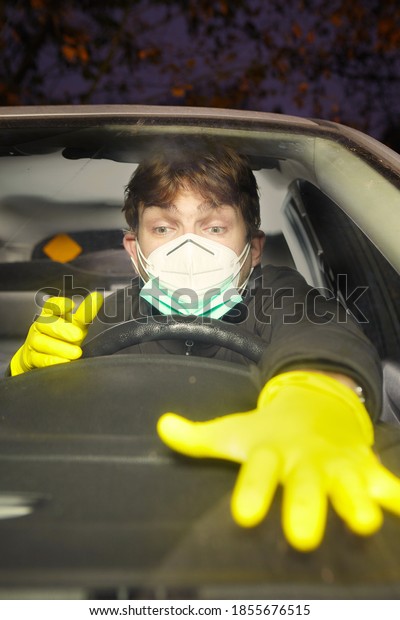Car driver crazy of coronavirus with mask\
and disinfectant