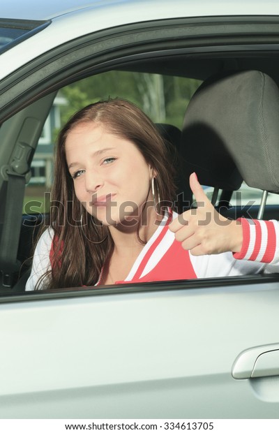 A Car driver happy
showing is thumb up.