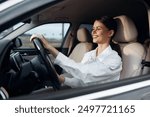 Car, driver, woman, smile a cheerful woman sits comfortably in the driver