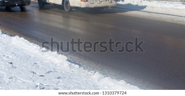 car drives in the\
winter on a dirty road