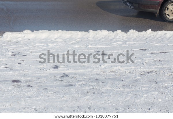 car drives in the
winter on a dirty road