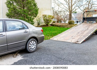 Car In Driveway With Tow Truck For Vehicle Due To Fuel Leak That Damaged Pavement Covered In Cat Litter To Absorb The Gas