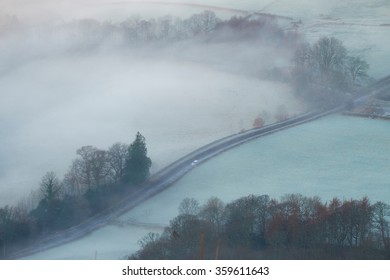 A Car Driving Along An Icy Road In The English Countryside, Lake District UK.