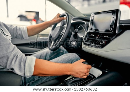 Car Driving Concept. Driver Shifting To Drive Mode. Hand on Transmission Stick Closeup