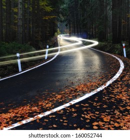 Car Driving Down The Night Forest Road