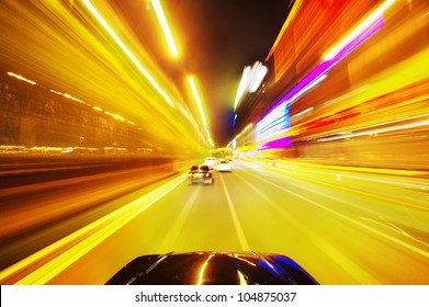 Car driving fast down in the city