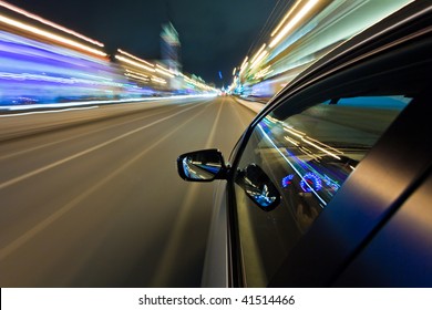 Car Driving Fast In The Night City