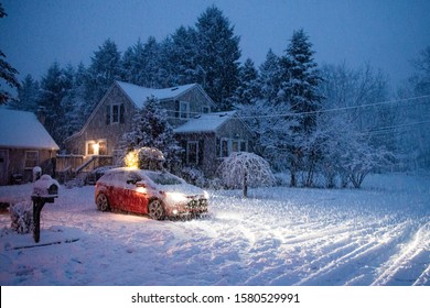 Car Driving Home With A Lit Christmas Tree On The Roof