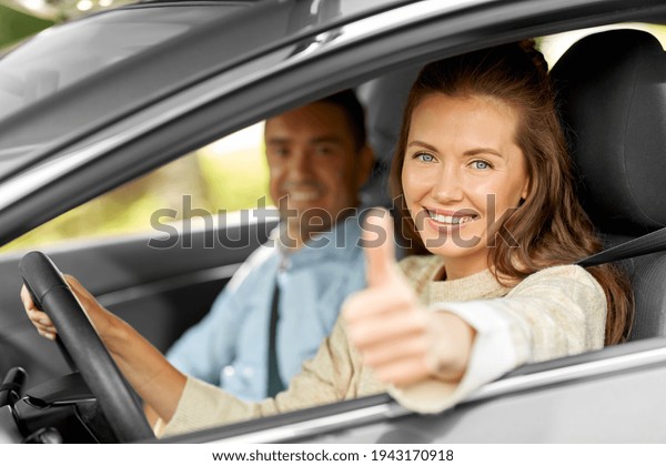 car\
driving instructor and woman showing thumbs\
up