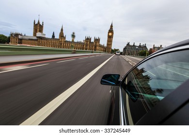 Car driving in london beside Big Ben.