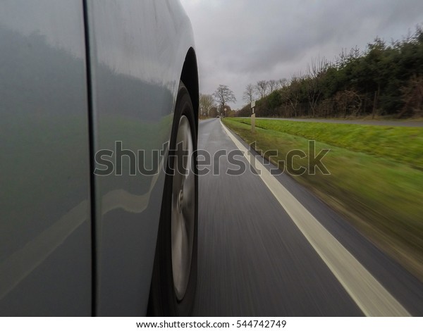 car driving on a\
asphalt road - close up