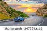 car driving on beautiful road in colorful sunset landscape in summer. Nature scenery on coastline highway. Europe travel trip in sea coast road landscape. summer vacation journey on road at the beach.